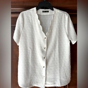 White blouse with gold buttons. Short sleeve.